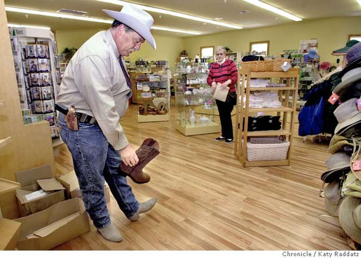 SHOWN: Lt. John F. Quinlan of the San Mateo Sheriff's Office looks at boots in the upstairs part of Cunha grocery, which is like an old-time general store. Cunha grocery store on Main St. in Half Moon Bay will re-open tomorrow (Wednesday May 12, 2004) after burning down last year. Shoot daate is May 11, 2004; writer is Ryan Kim. Katy Raddatz / The Chronicle