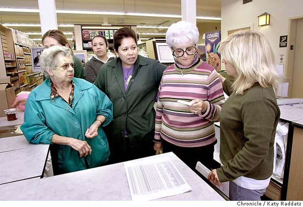 SHOWN: Beverly Cunha Ashcraft, owner of Cunha grocery (wears striped sweater and white hair, second from RIGHT), talks with her business manager Kathy Llorente (cq) (RIGHT)--ladies on left are cashiers who are trying to overcome a computer problem. Cunha grocery store on Main St. in Half Moon Bay will re-open tomorrow (Wednesday May 12, 2004) after burning down last year. Shoot daate is May 11, 2004; writer is Ryan Kim. Katy Raddatz / The Chronicle