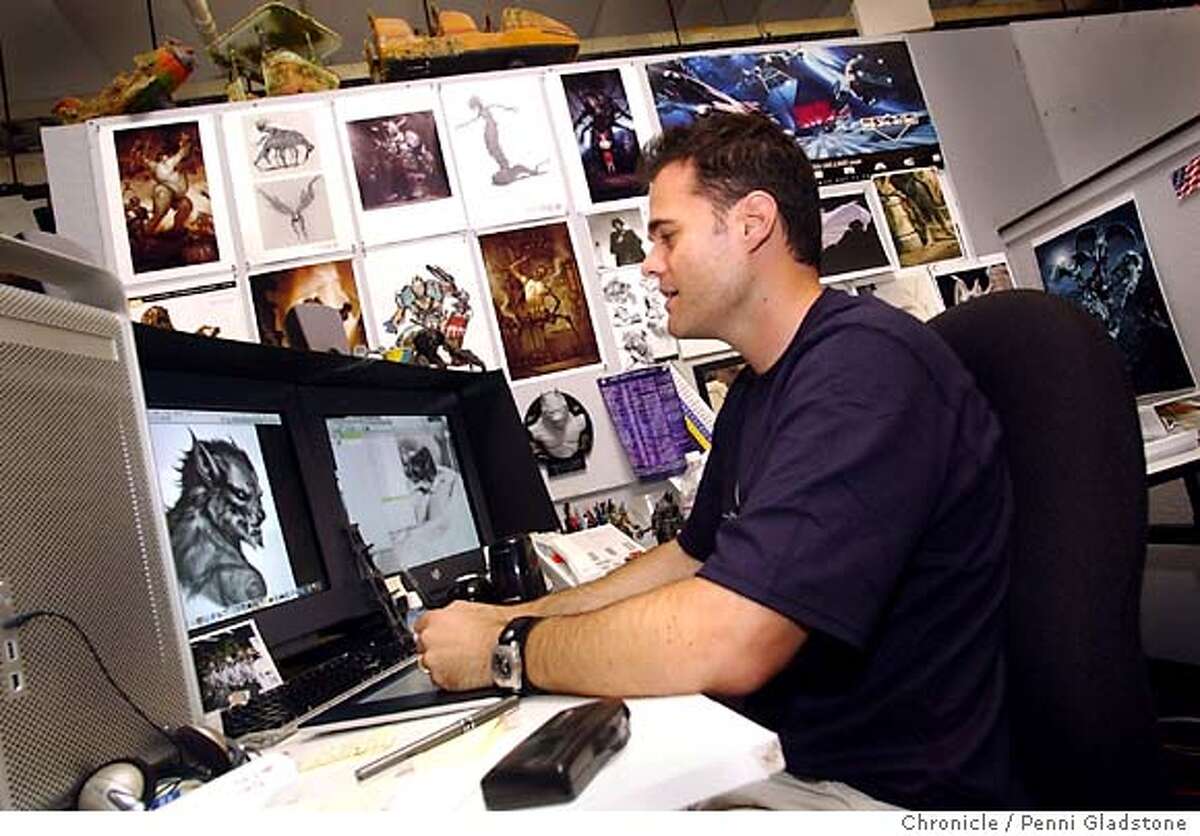 Christian Alzmann works at his desk surrounded by toys and drawings. VAN HELSING, first big special effects movie of the summer. Visual effects art dir. photo taken on 4/28/04 in San Rafael, CA. photo by Penni Gladstone/The San Francisco Chronicle