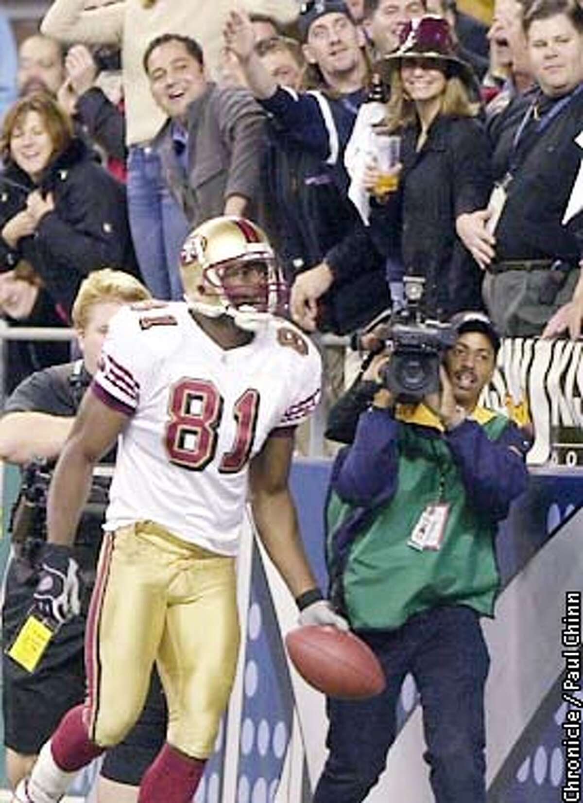 49ERS9-C-14OCT02-SP-PC After autographing the ball, Terrell Owens hand delivered the game ball to a fan in the stands after scoring the game-winning TD. The 49ers played the Seattle Seahawks at Seahawk Stadium. PAUL CHINN/S.F. CHRONICLE