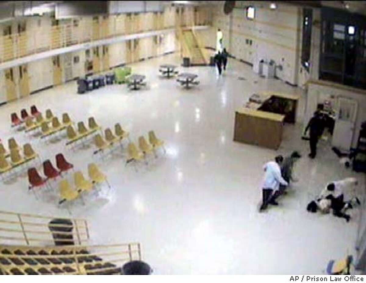 One of two wards of the California is seen being beaten by a corrections employee at right in this image from a surveillance camera taken at the N.A. Chaderjian Youth Correctional Facility in Stockton, Calif., Jan. 20, 2004. The video tape was shown to reporters at the Capitol by State Sen. Gloria Romero, D-Los Angeles, and Don Spector, director of the Prison Law Office Thursday, April 1, 2004. Romero and Spector are urging prosecution of the employees. The second wardcan be seen lying on the floor above the fight.(AP Photo/Courtesy of Prison Law Office)