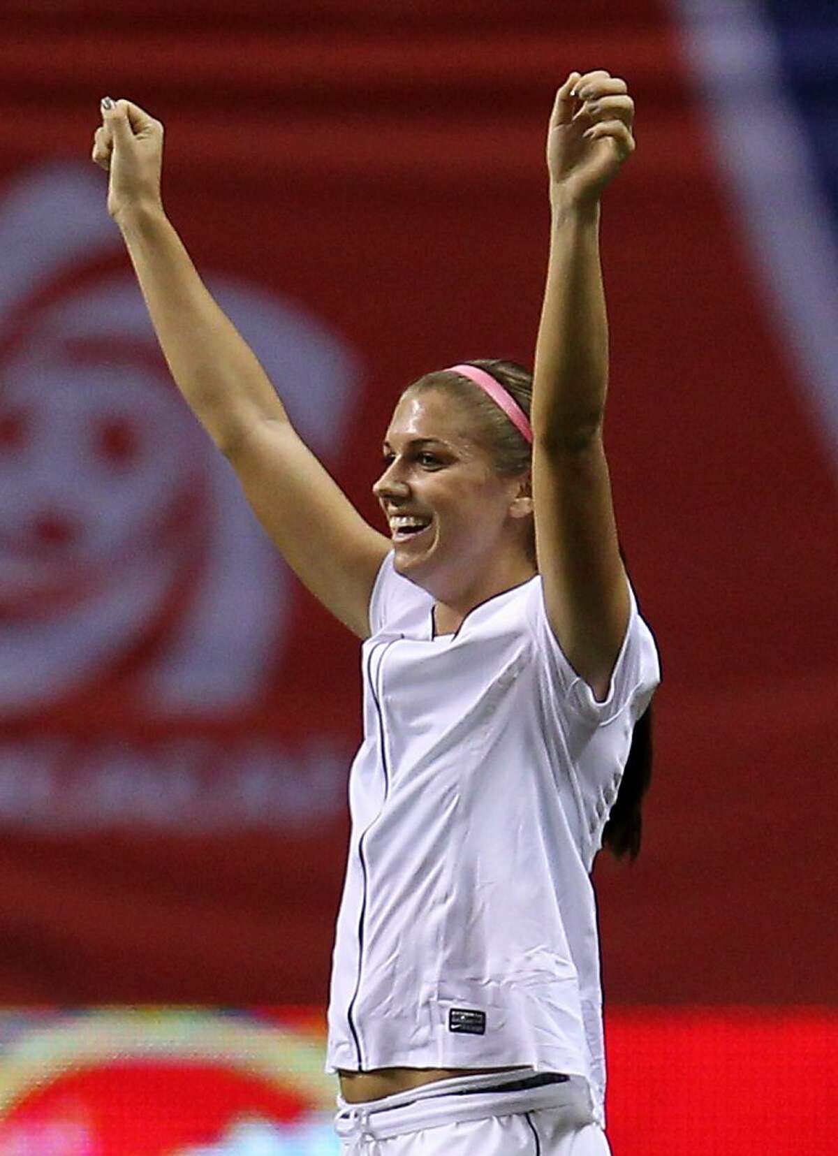United States' Alex Morgan (13) celebrates her team's 3-0 win over Costa Rica in CONCACAF women's Olympic qualifying soccer game action at B.C. Place in Vancouver, British Columbia, Friday, Jan. 27, 2012. (AP Photo/The Canadian Press, Jonathan Hayward)