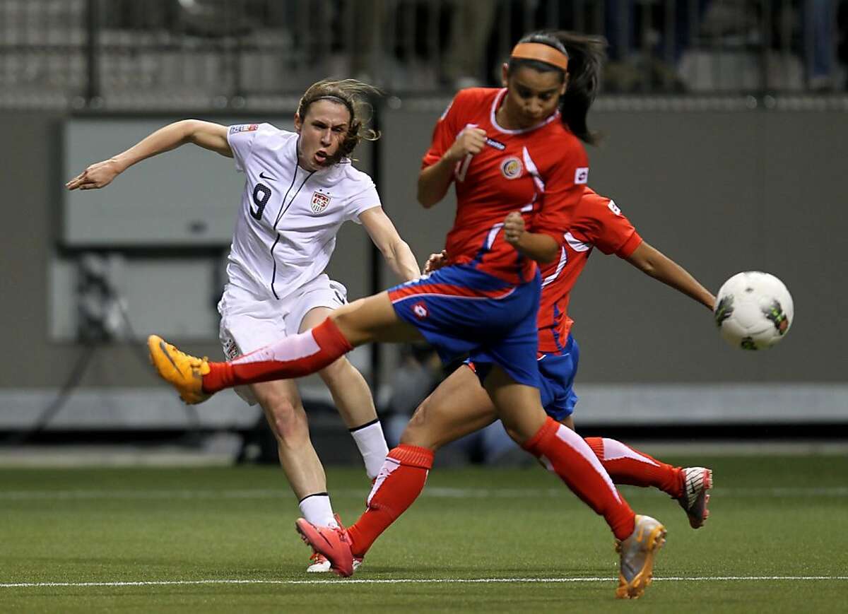 United States' Heather O'Reilly (9) tires to get a shot past Costa Rica's Shirely Cruz (10) during the first half of CONCACAF women's Olympic qualifying soccer game action at B.C. Place in Vancouver, British Columbia, Friday, Jan. 27, 2012. (AP Photo/The Canadian Press, Jonathan Hayward)