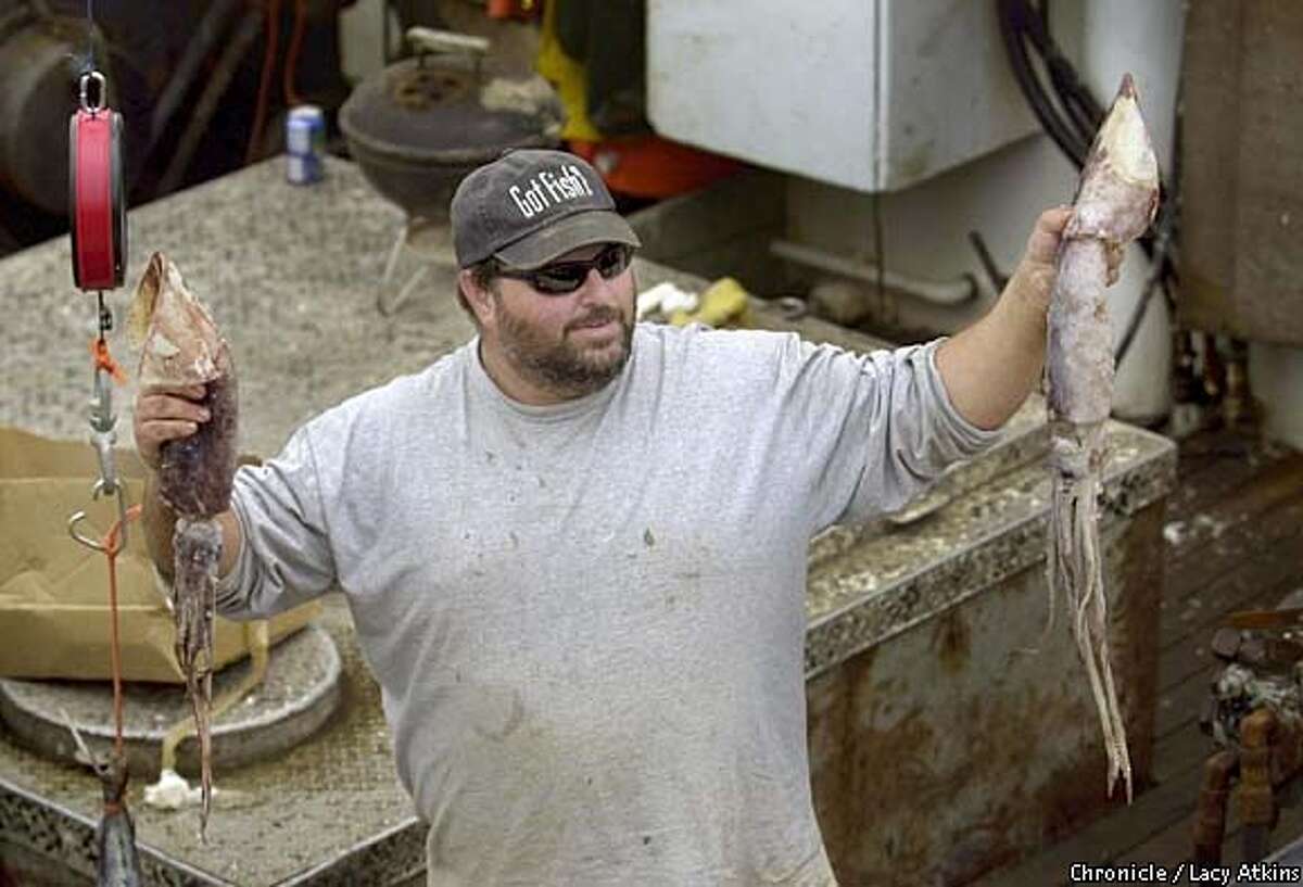 David Pennisi makes a sale of fresh squid from his boat "Relentless" in Half Moon Bay. Chronicle photo by Lacy Atkins