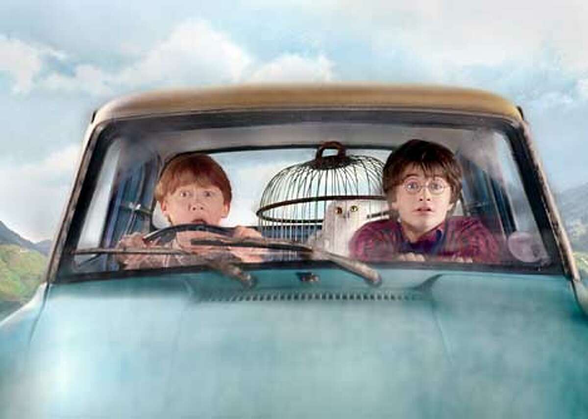(L-r) Ron (RUPERT GRINT), Hedwig and Harry (DANIEL RADCLIFFE) in the flying Ford Anglia in Warner Bros. Pictures' "Harry Potter and the Chamber of Secrets." PHOTOGRAPHS TO BE USED SOLELY FOR ADVERTISING, PROMOTION, PUBLICITY OR REVIEWS OF THIS SPECIFIC MOTION PICTURE AND TO REVMAIN THE PROPERTY OF THE STUDIO. NOT FOR SALE OR REDISTRIBUTION HARRY POTTER and all related indicia are trademarks of and �2002 Warner Bros. All Rights Reserved. Harry Potter Publishing Rights �J.K.R.