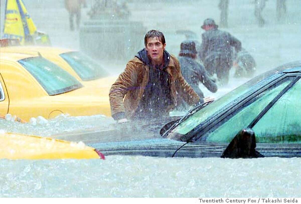 Amidst a horrific flood, Samuel Hall (Jake Gyllenhaal) searches for his friend in Twentieth Century Fox / Takashi Seida's "The Day After Tomorrow." (AP Photo/Takashi Seida)