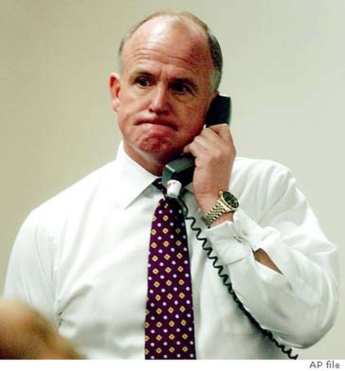 ** FILE ** Former San Francisco Police Department Police Chief Alex Fagan Sr. is seen on the phone inside the Hall of Justice in San Francisco, in this Monday, March 3, 2003, file photo. Fagan Sr. retired as the city's emergency services director Tuesday, March 30, 2004, as new details surfaced about his actions at an Arizona hotel where he and his son got into a drunken fight that resulted in the younger man's arrest. San Francisco Mayor Gavin Newsom's office announced in a brief statement that Fagan,53, would be leaving his $195,290 a year job "due to personal and family matters and in the best interest of the city." Still considered a member of the police department, he has been placed on administrative leave until his retirement becomes effective. (AP Photo/Marcio Jose Sanchez)