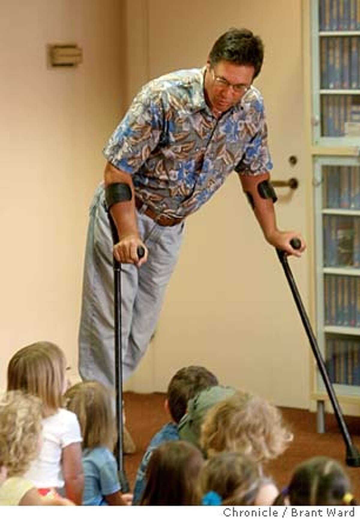 30BB0112.JPG Tim Cain contracted polio as a child. He uses crutches to get around. He calls attention to them early with a group of children...showing how he swings and walks with them. Tim Cain is a musician who does performances all over the Bay Area for children. Here he is singing for the Osher Jewish Community Center in San Rafael. BRANT WARD / The Chronicle MANDATORY CREDIT FOR PHOTOG AND SF CHRONICLE/ -MAGS OUT