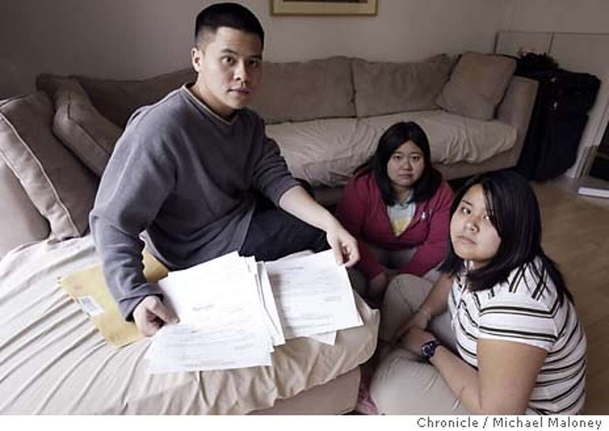 From left, Dave Cuevas, Donna Cuevas and Dominique Cuevas look over the deportation papers in the living room of their parent's Fremont home. The Cuevas family of Fremont has lived illegally in the East Bay since 1996 and is now on final order of deportation. They are to leave the country and return to the Philippines April 7th. Delfin Cuevas arrived in the United States in 1984 on a visitor's visa. His wife, Angelita, and their toddler children followed in 1985. The adult Cuevas children -- Dale, 23, Donna, 24, and Dominique, 20 - - say they were not aware of their undocumented status until deportation papers arrived in December. They speak only English and remember little about the Philippines. Photo by Michael Maloney / The Chronicle