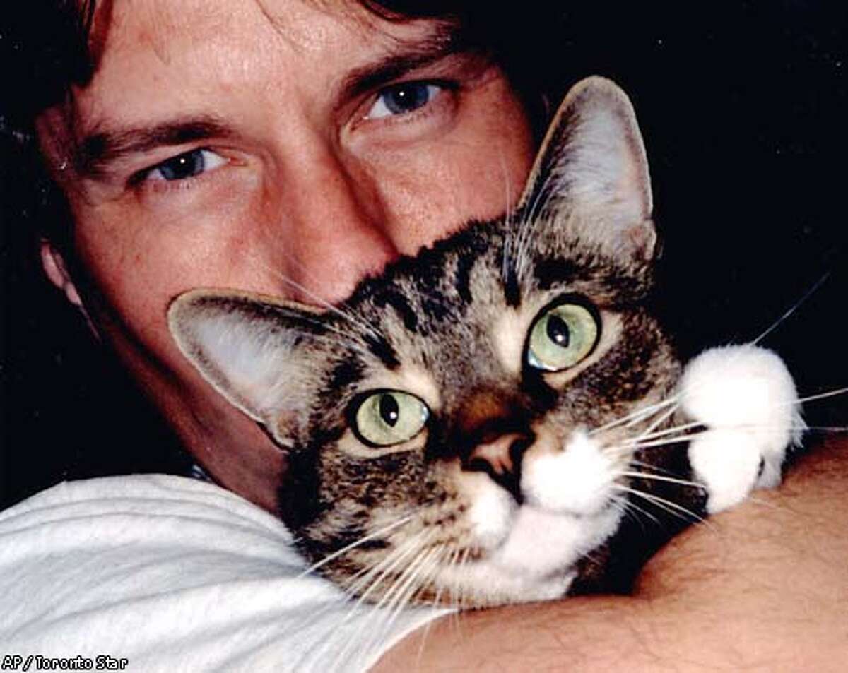 Andrew Wysotski hold his cat Fu in this undated handout family photo. Wysotski and Lori Learmont, formerly of Oshawa, Ont., who allege Air Canada lost their tabby cat, are seeking $5 million US in compensation. Their lawsuit is the largest ever filed over a cat, said their lawyer in San Francisco, where they now live. (AP PHOTO/Toronto Star - HO)