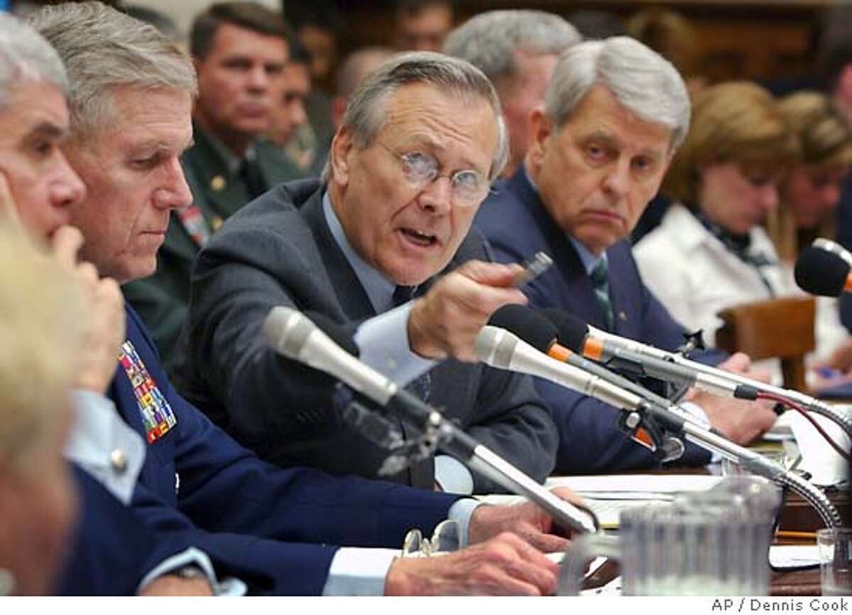 Defense Secretary Donald Rumsfeld gestures as he answers a question asked by a House Armed Services Committee member during the committee hearing on Capitol Hill Friday, May 7, 2004, on prisoner abuse in Iraq. At left, Gen. Richard Myers, Chairman of the Joint Chiefs of Staff, and right, Les Brownlee, acting Secretary of the Army. (AP Photo/Dennis Cook)