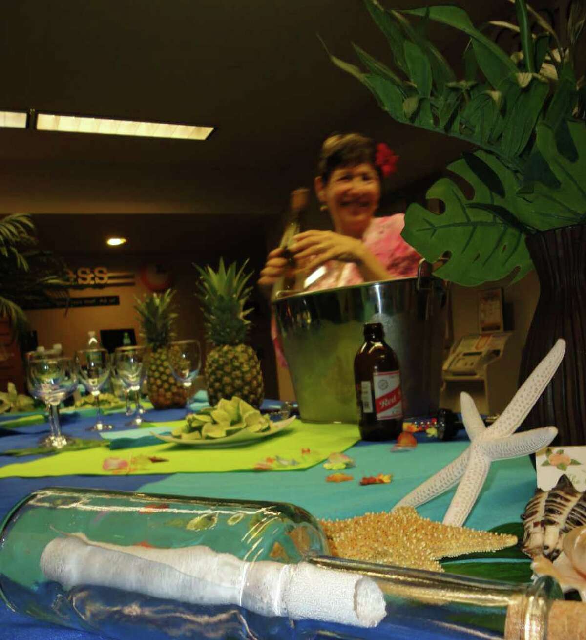 Suzy Hooper, a Westport Library staff member, tended bar at the Tropical Island Party on Friday, which closed a month of WestportREADS events related to the book, "I Was Amelia Earhart."
