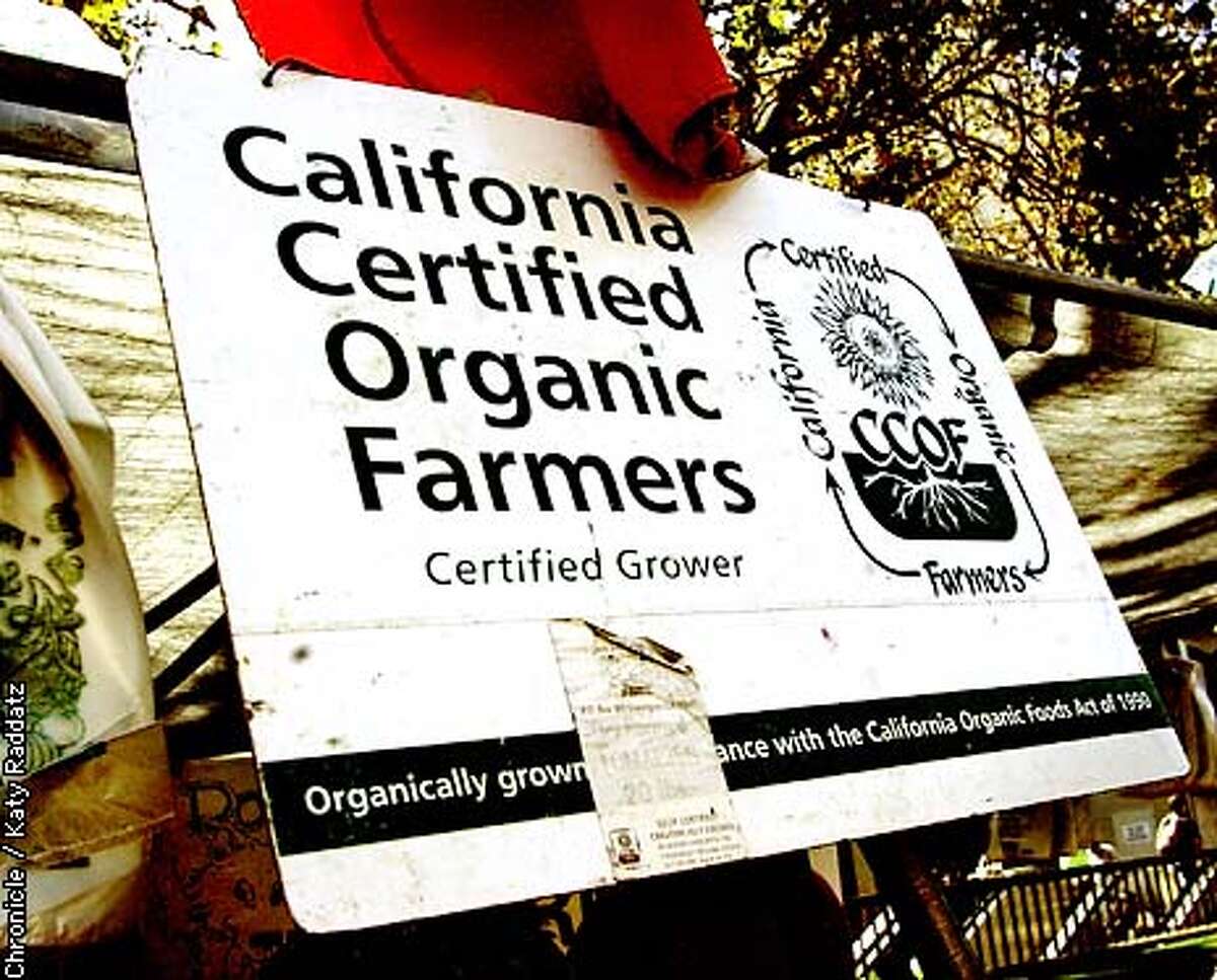 PHOTO BY KATY RADDATZ--THE CHRONICLE Story about the boom in the organic food industry. SHOWN: At the Civic Center Farmers' Market in San Francisco, we find many tasty treats, and this official organic sign over the Two Dor Farm stand.