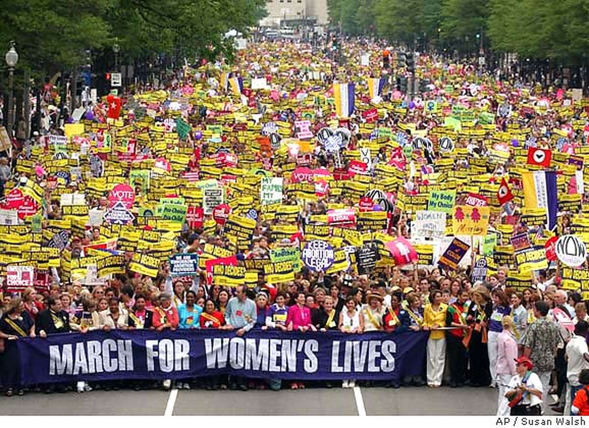 Women march down Pennnsylvania Avenue in Washington, Sunday, April 25, 2004, during a abortion-rights rally and march. The rally, which focused on protecting women's reproductive rights, included men and women from across the country along with activists from nearly 60 countries (AP Photo/Susan Walsh)