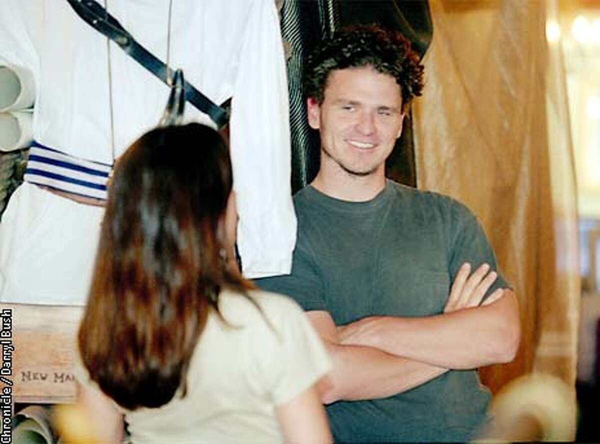 Author Dave Eggers smiles while talking inside to associates at he combination pirate themed retail store and ecucational writing lab, called 826 Valencia in San Francisco. That's a pirate outfit in background left. Chronicle Photo by Darryl Bush