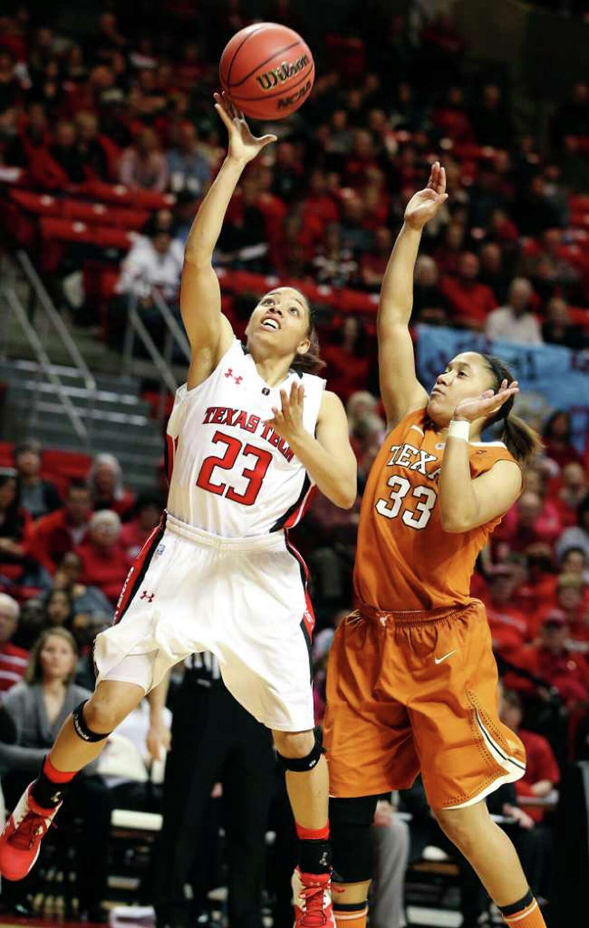 Texas Tech's Monique Smalls (left) gets by Texas' Ashleigh Fontenette for a shot.