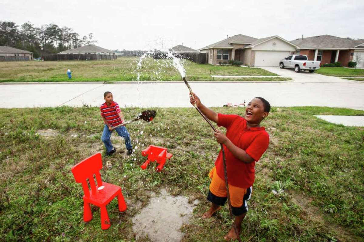 Daione Joseph, 9, left, and Tony Green, 8, play in an empty lot in Leland Woods, which was hit hard in the real-estate bust. See more photos of the neighborhood at chron.com and on the iPad app.
