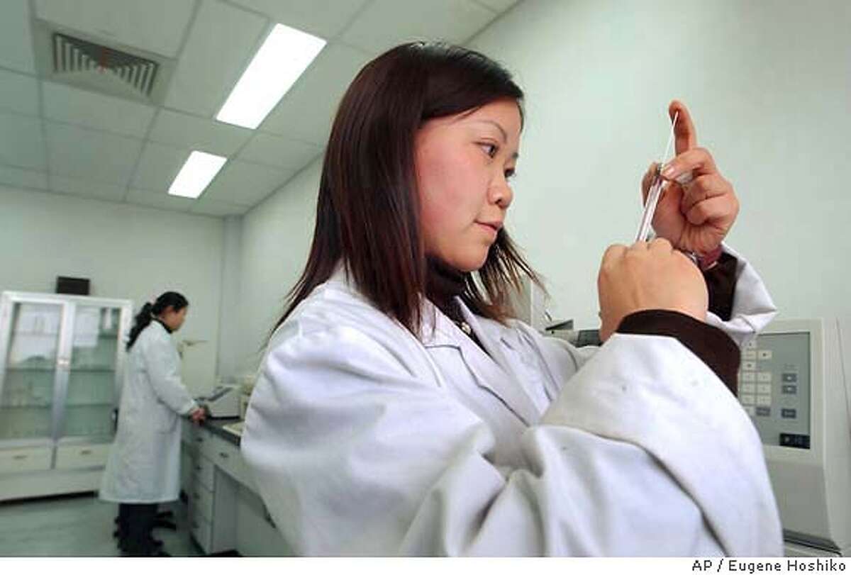 SPECIAL FOR THE SAN FRANCISCO CHRONICLE--Scientists work at a lab at the National Shanghai Center for New Drug Safety Evaluation and Research (NDSER) Friday April 2, 2004 in Zhangjiang Industrial Park in Shanghai, China. (AP Photo/Eugene Hoshiko) SPECIAL FOR THE SAN FRANCISCO CHRONICLE, AUTH ED RICK ROMAGOSA