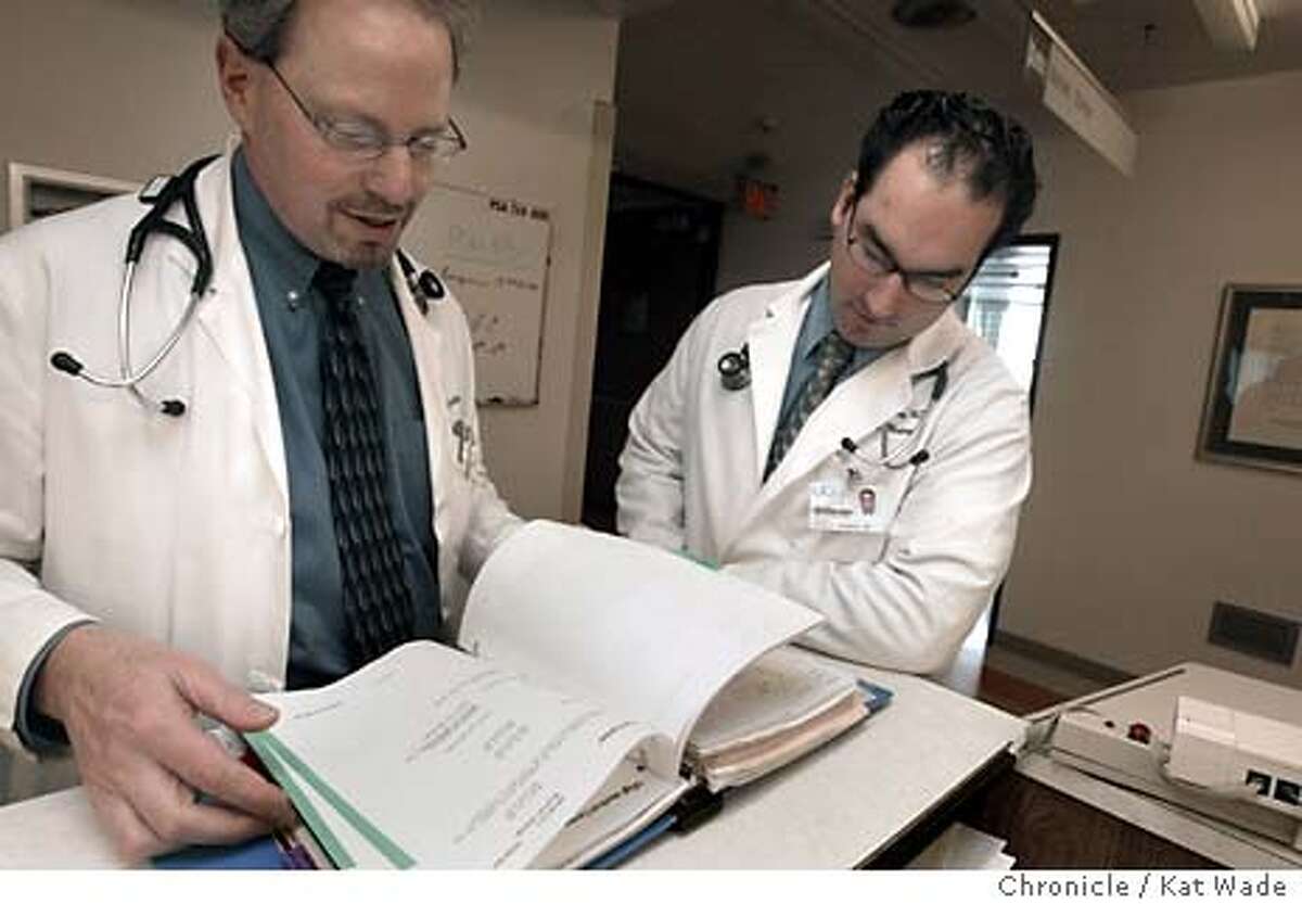 Co-authors of a popular new book on medical errors, Internal Bleeding, (L to R) Robert M. Wachter, M.D. (CQ) Chief of the Medical Service at UCSF Medical Center and Kaveh G. Shojania, M.D. (CQ) Assistant professor of Medicine at UCSF look over a patient chart on the medical service floor at UCSF on 2/19/04 in San Francisco. Kat Wade / The Chronicle