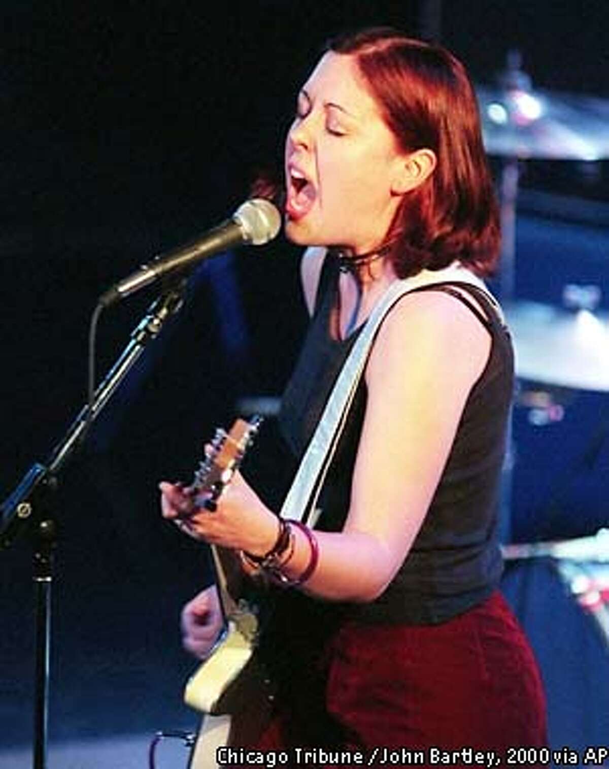 Guitarist Corin Tucker, a member of the all-girl punk-rock band Sleater-Kinney, performs at the Metro during the Noise Pop music festival in Chicago May 12, 2000. Tucker, along with Carrie Brownstein on guitar and Janet Weiss on drums, are among more than 50 bands that played to packed rooms in smaller clubs on the city's north side. Noise Pop, a fixture in San Francisco for the past eight years, finally left its nest for the first time to play at Chicago venues. (AP Photo/Chicago Tribune, John Bartley)