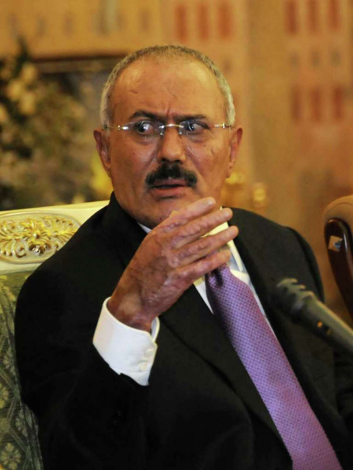 FILE - In this Saturday, Dec. 24, 2011 file photo, Yemen's President Ali Abdullah Saleh speaks to reporters during a news conference at the Presidential Palace in Sanaa, Yemen. Yemen's President's office says Yemeni leader Saleh has arrived in London en route to the U.S. (AP Photo/Mohammed Hamoud, File)