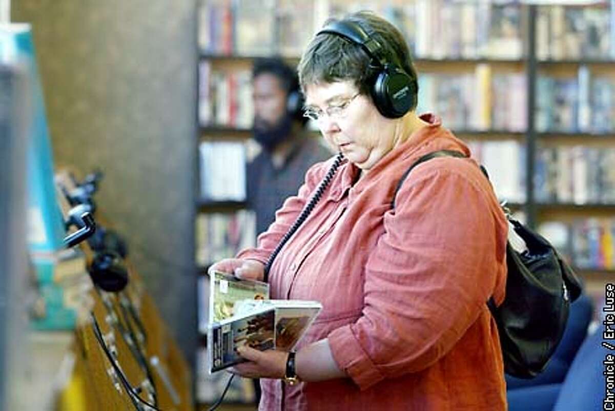 Customer Ramona Davies, listens to samples of classical music at SF Tower Music in the annex store in San Francisco. BY ERIC LUSE/THE CHRONICLE