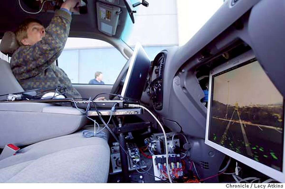 Brian Hall show off the inside of their robotic vehicle that they plan to race in March from LA to Las Vegas in the DARPA Grand Challangerace in, Thurs, Jan.22, 2004. Lacy Atkins / The Chronicle