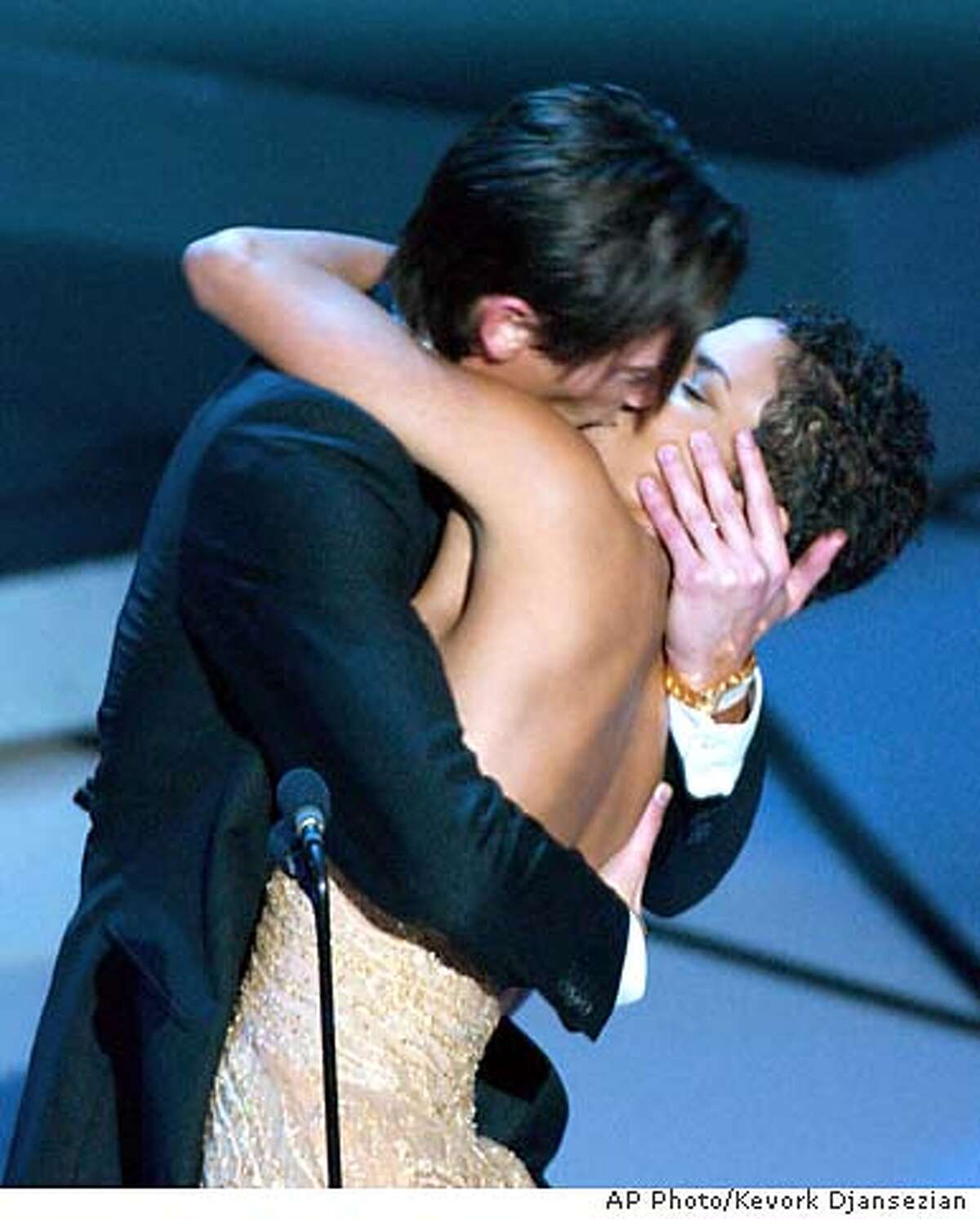 **EMBARGOED AT THE REQUEST OF THE MOTION PICTURE ACADEMY FOR USE UPON CONCLUSION OF ACADEMY AWARDS TELECAST** Actor Adrien Brody suprises presenter Halle Berry with a kiss after he won the Oscar for best actor for his work in The Pianist at the 75th annual Academy Awards Sunday, March 23, 2003, in Los Angeles. (AP Photo/Kevork Djansezian)