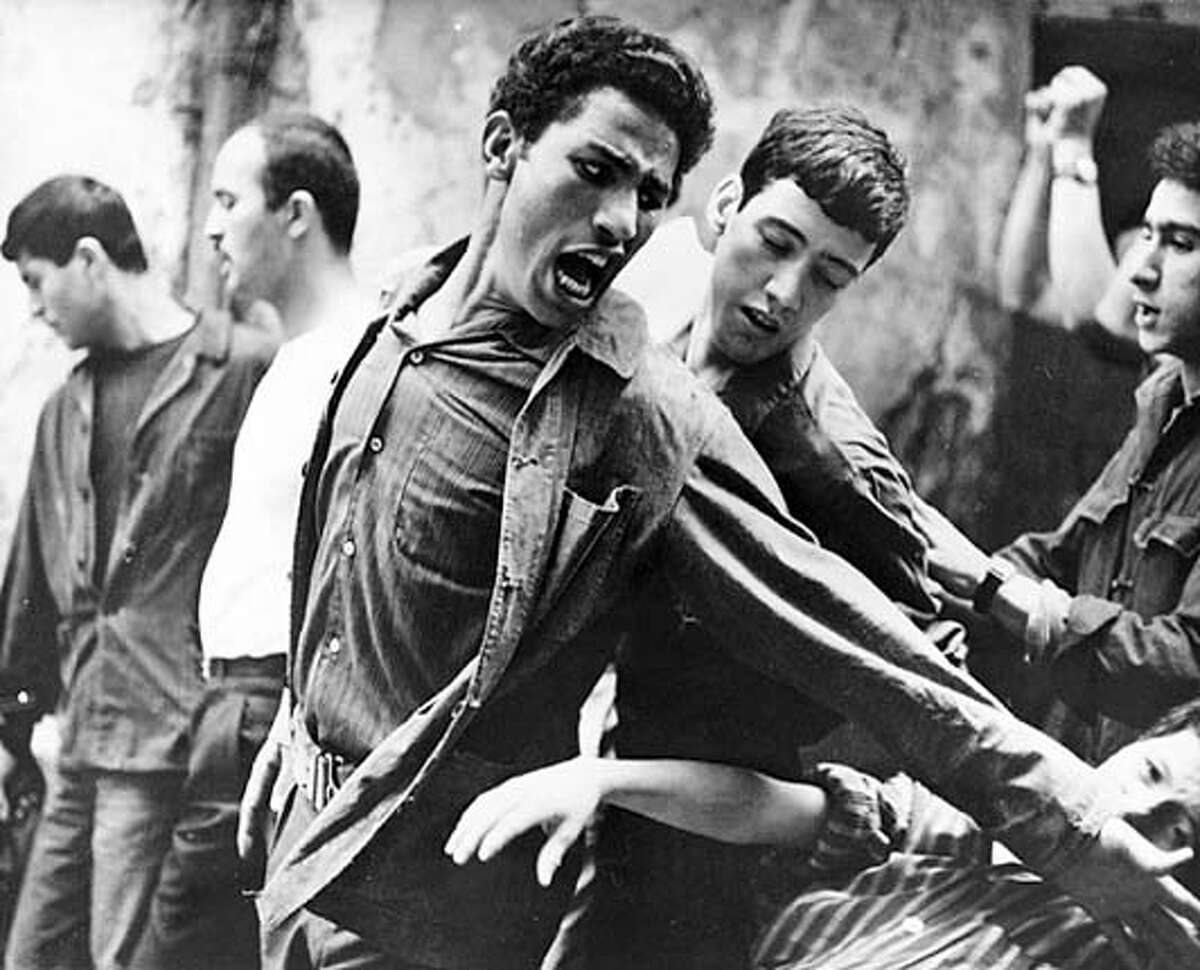 ALGIERS13 Brahim Haggiag (center with arm outstretched) as revolutionary leader Ali La Pointe in a scene from "The Battle of Algiers."