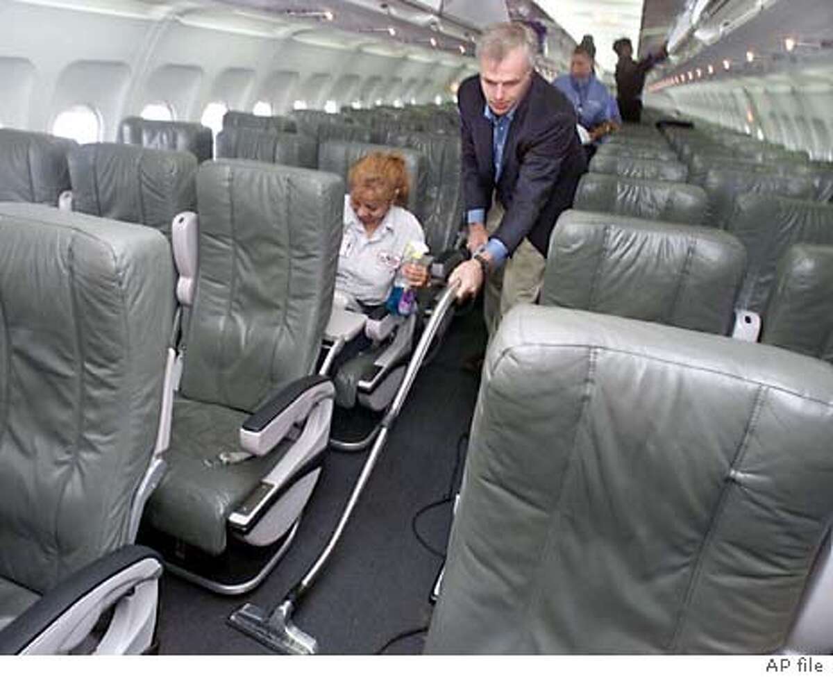 ** FILE ** David Neeleman, founder and CEO of jetBlue Airways, wields a vacuum cleaner as he pitches in to help out the cleaning crew prepare an aircraft for the airline's inaugural trip to New Orleans, at New York's John F. Kennedy International Airport, July 26, 2001. JetBlue was No. 1 in quality among U.S. airlines in 2003, the first year that it carried enough passengers to be ranked, according to an annual study released Monday, April 5, 2004. (AP Photo/Richard Drew)