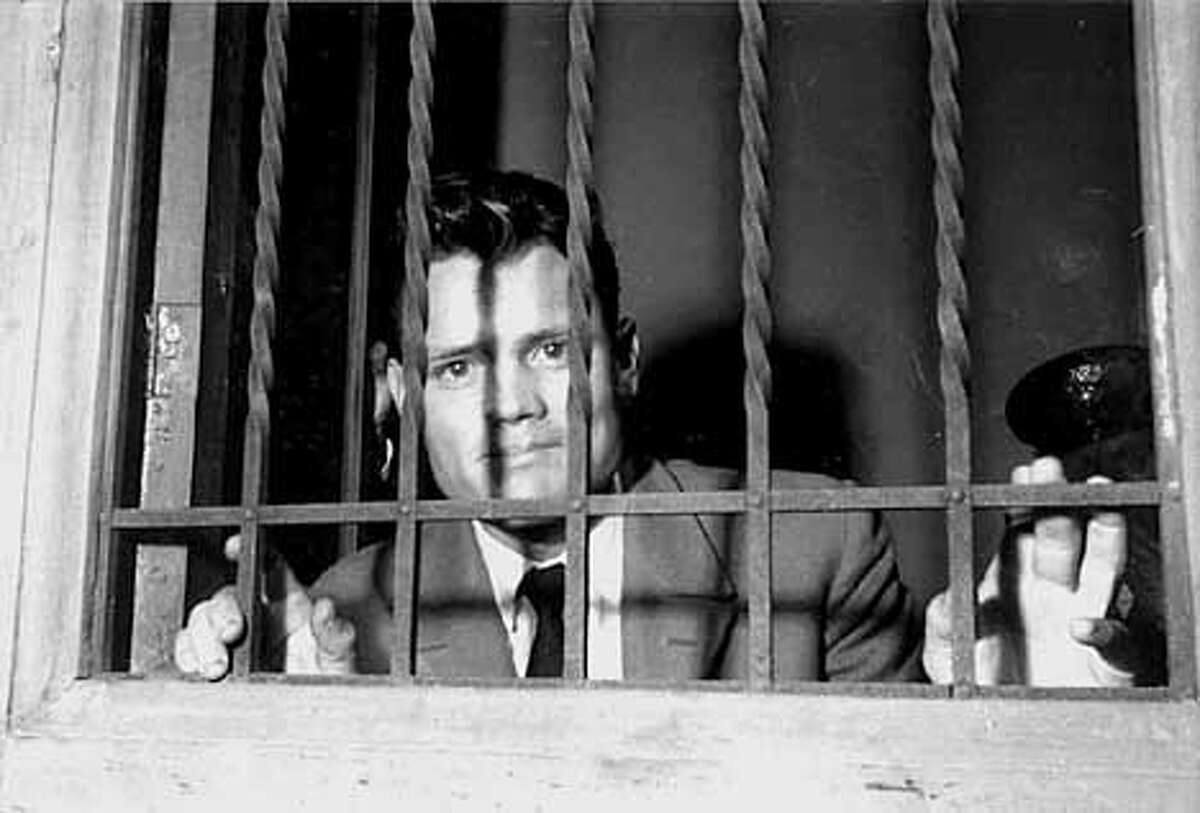 THIS IS A HANDOUT IMAGE. PLEASE VERIFY RIGHTS. POP12A-C-10SEP02-DD-HO 1. Chet behind bars, Lucca, Italy, 1959 (photo by F. Ercolini; courtesy of Archivio Circolo del Jazz, Lucca) (HANDOUT PHOTO) PLEASE VERIFY RIGHTS AND USAGE