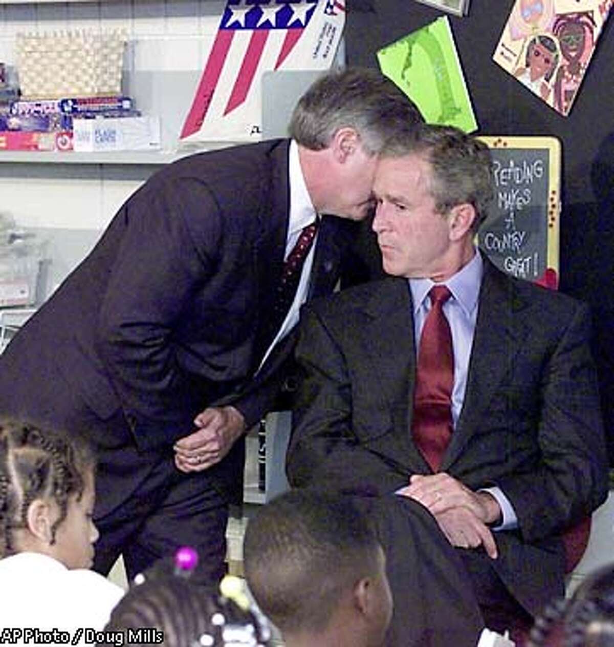 President Bush's Chief of Staff Andy Card whispers into the ear of the President to give him word of the plane crashes into the World Trade Center, during a visit to the Emma E. Booker Elementary School in Sarasota, Fla., Tuesday, Sept. 11, 2001. (AP Photo/Doug Mills) .. ALSO RAN 09/23/2001, SPECIAL SECTION