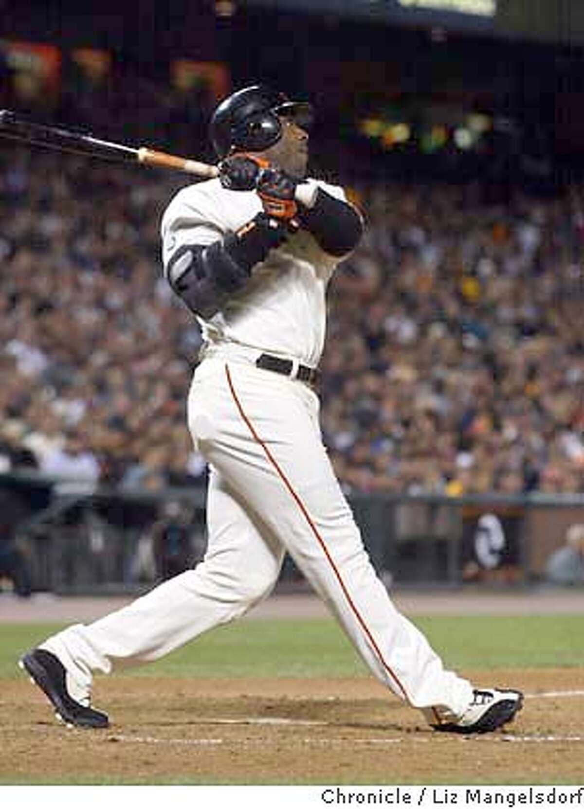 San Francisco Giants' Barry Bonds flips his bat after hitting a