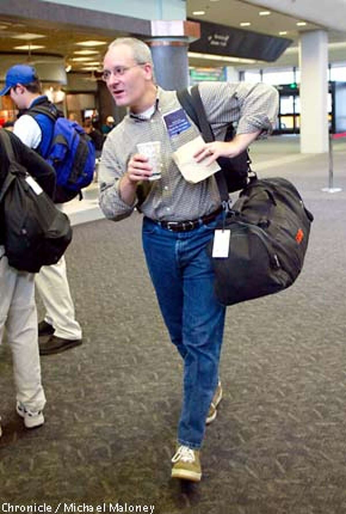 At SFO, passenger Tom Furnas of Cleveland prepares to pass through the security checkpoint with a double mocha in his hand. He was returning to Cleveland after a business trip in SF. He passed through the metal detectors with no problem. New security measures may soon ban any open containers of food and drink at airport security checkpoints. At SFO, it is currently not being enforced. CHRONICLE PHOTO BY MICHAEL MALONEY
