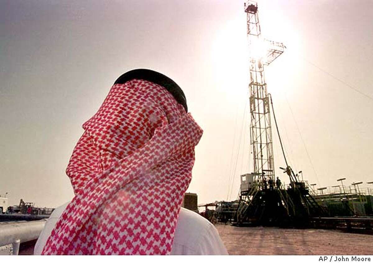 Khaled al Otaiby, an official of the Saudi oil company Aramco watches progress at a rig at the al-Howta oil field near Howta, Saudi Arabia, on Feb. 26, 1997. Energy is the big strand in a web of U.S.-Saudi economic ties that has grown in the six years since an American-led army rolled back Iraqi aggression in the Persian Gulf. (AP Photo/John Moore)