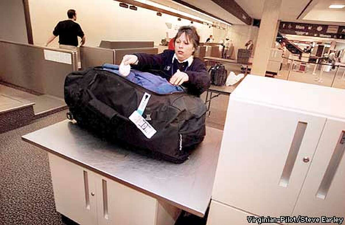 Pre-board screener Kathy Stephenson swabs a checked back to check for explosive traces at Norfolk International Airport on Wednesday, March 20, 2002. ( Steve Earley / The Virginian-Pilot ) cq
