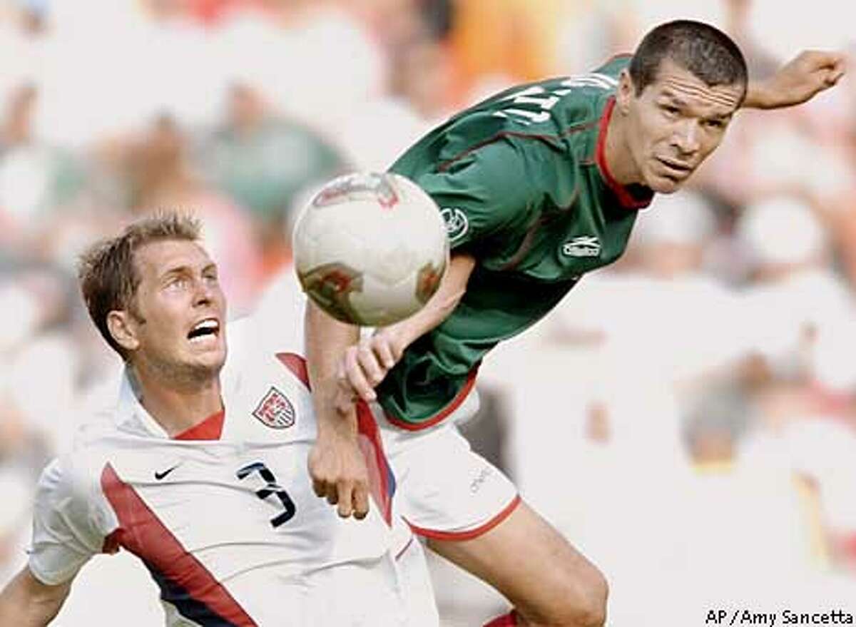 ** RETRANSMISSION FOR ALTERNATE CROP ** Mexico's Jared Borgetti, right, goes for the ball against USA's Gregg Berhalter during action in their 2002 World Cup second round playoff soccer match at the Jeonju World Cup Stadium at Jeonju, South Korea, Monday, June 17, 2002. (AP Photo/Amy Sancetta)
