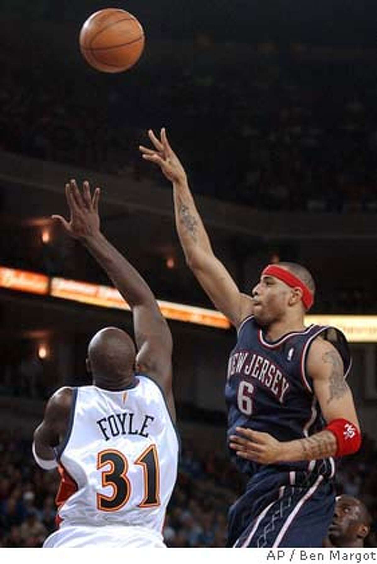 New Jersey Nets' Kenyon Martin (6) goes up for a shot over Golden State Warriors' Adonal Foyle (31) in the first half Friday, March 5, 2004, in Oakland, Calif. (AP Photo/Ben Margot)