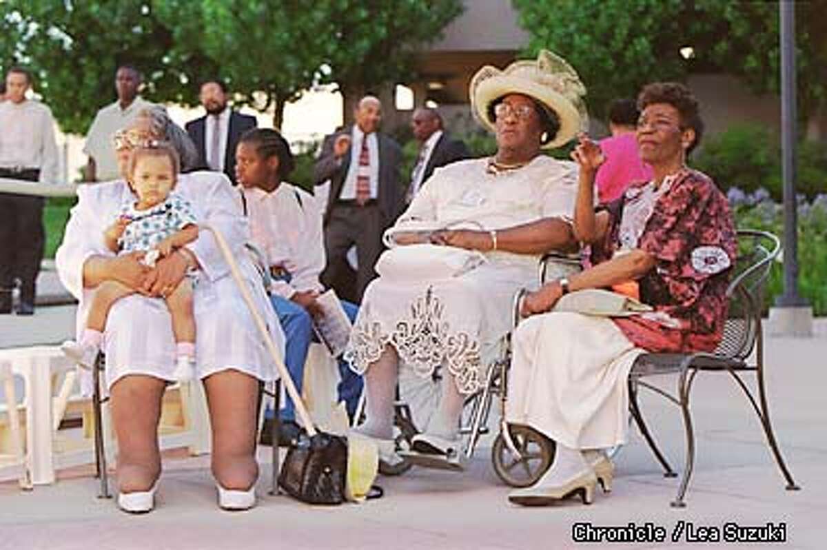 FROM LEFT: Lenore B. Fields who is holding grandaughter, Brittany Nicole Fields, 1, on her lap, Mabel Hurdle, and Edna Hurdle Fuller wait in the courtyard at the Embassy Suites in Walnut Creek before the family portrait is taken. Photo By Lea Suzuki