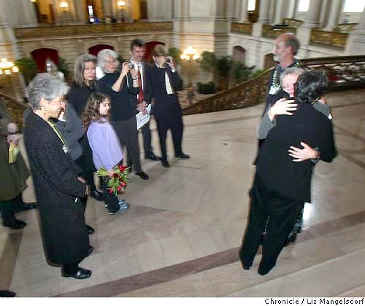 samesex25_019_lm.JPG Same-sex marriages continue at City Hall. Chris Harris (facing camera) hugs her partner of 29 years Sally Hand after their wedding ceremony at city hall. They are surrounded by friends and family. (they are quoted in Suzanne Herel's story) Event on 2/25/04 in San Francisco. Liz Mangelsdorf / San Francisco Chronicle MANDATORY CREDIT FOR PHOTOG AND SF CHRONICLE/ -MAGS OUT