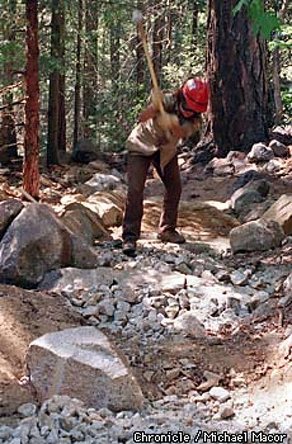 Yosemite National Park. Califronia Conservation Corp member crushes rock along the "MIST TRAIL" to repair damage to trail caused by January floods. The popular trail leads to Nevada Falls. Chronicle Photo: Michael Macor