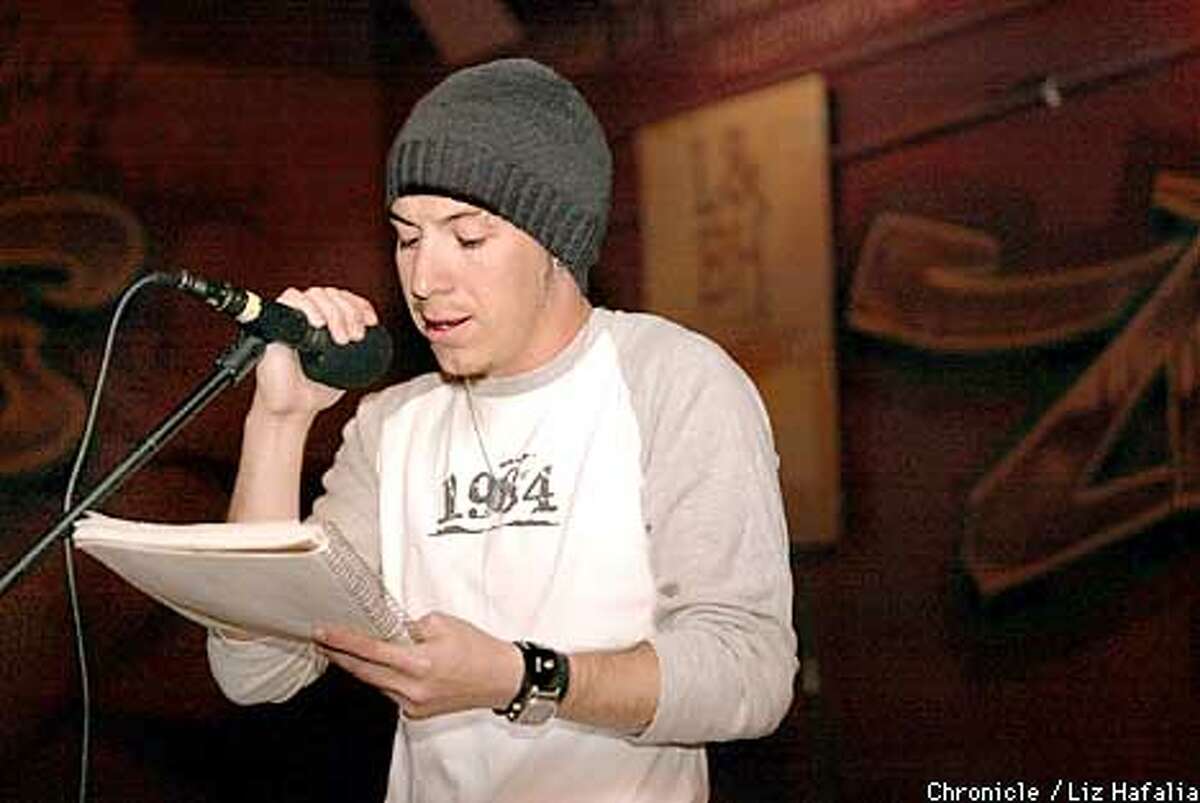 Seven (real name is William Iles and only wants 'Seven' used), 26 years old, reading his poem at Rafael's Bar and Cafe in Vallejo. (PHOTOGRAPHED BY LIZ HAFALIA/THE SAN FRANCISCO CHRONICLE)