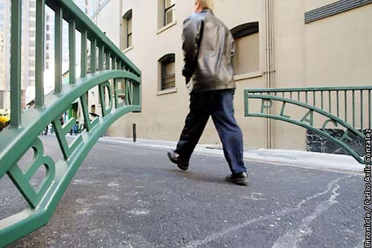 A pedestrian makes his way past the new gates on Belden Place in San Francisco, Ca., on Monday, May 6, 2002. The street has seen a series of improvements that include new gates to prevent traffic and repavement. (CARLOS AVILA GONZALEZ/SAN FRANCISCO CHRONICLE)
