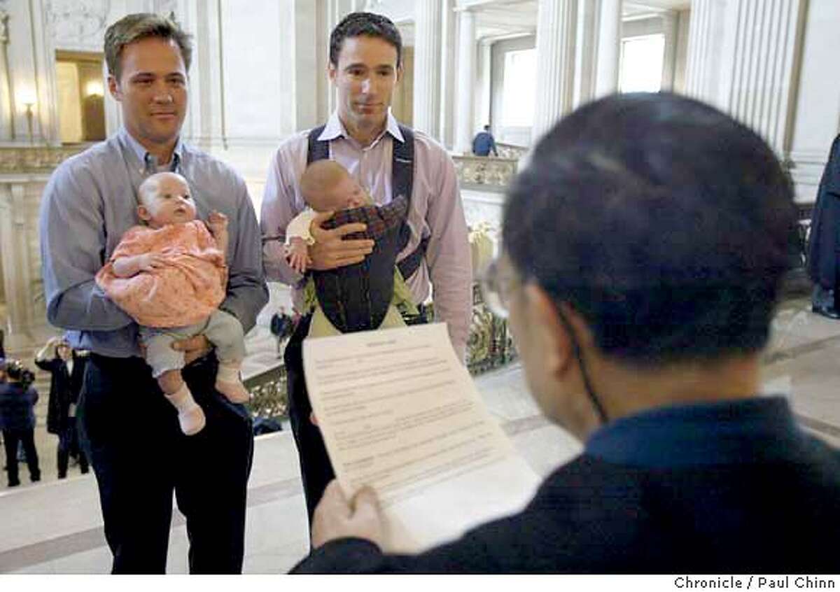 gaymarriage_136_pc.JPG Holding the twin daughters Sophia and Elizabeth, Eric Etherington (left) exchanges marriage vows with Doug Okun in front of marriage commissioner Richard Ow on Friday. Same sex couples waited up to two hours to get legally married at City Hall on 2/13/04 in San Francisco. PAUL CHINN / The Chronicle