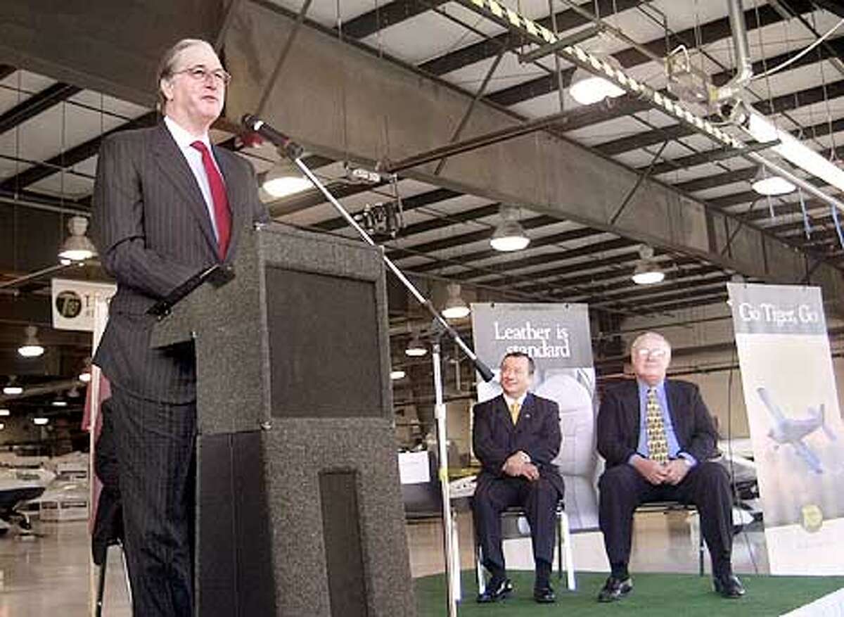 Sen. Jay Rockefeller, D-W. Va., talks at the rollout ceremony for the first three AG-5B built at the Eastern West Virginia Regional Airport in Martinsburg, W.Va., Monday, Dec. 3, 2001. Seated at center is Taiwan's Vice Ministerof Economics Chi-Ming Yiin, and at right representative John Sickles. Backed by a consortium of Taiwanese investors, the company has labored on the four-person single engine plane for nearly four years. (AP Photo/The Journal, Ron Agnir)