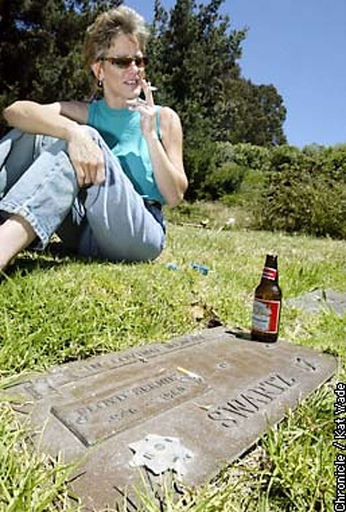 At Rolling Hills Cemetary in Richmond Kim Swartz visits the grave of her deceased husband, Floyd "Bernie" Swartz, a Pinole Police Officer who was killed in the line of duty in 1980 when she was pregnant with Amber. Sharing a beer and cigarette with Bernie she always promises him that she will find his daughter who disappeared in 1988. SAN FRANCISCO CHRONICLE PHOTO BY KAT WADE