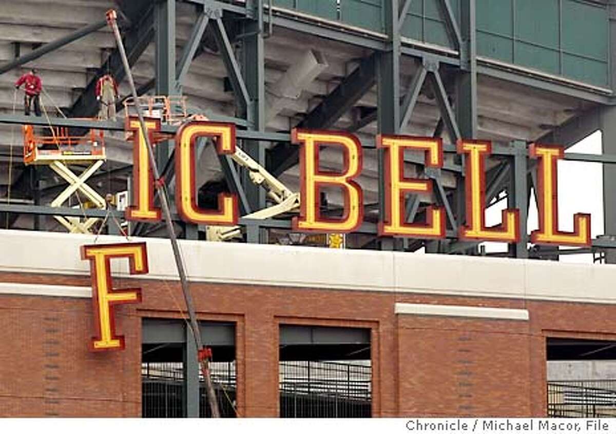 sbcpark017_mac.jpg Byron Hernandez, left and Ulises Rosas gently lower the letter' "F" from the word Pacific. Pacific Bell Park begins the transition to a new name, SBC Park. The change began this morning with the removal of the first of 10 exterior signs that ring the ballpark at First and King Sts. in downtown San Francisco. Michael Macor/ The Chronicle Byron Hernandez (left) and Ulises Rosas of the Golden Gate Sign Co. lower the letter F from the Pacific Bell Park sign. Bye, bye Pacific: Sign company workers Fernando Gonzalez (left) and Jeff Piazzo lean the huge Pacific Bell Park letters against a wall.