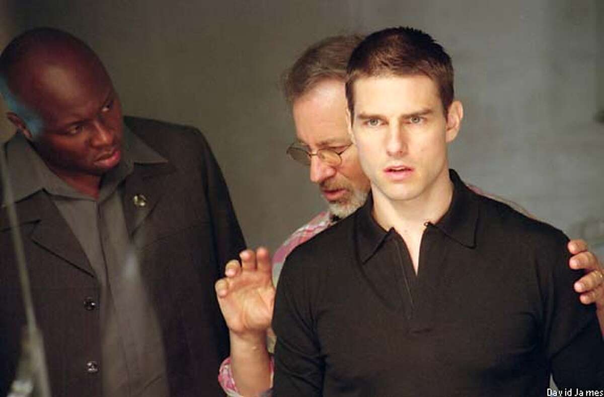 Steven Spielberg, center, directs Tom Cruise and Steve Harris on the set of "Minority Report."