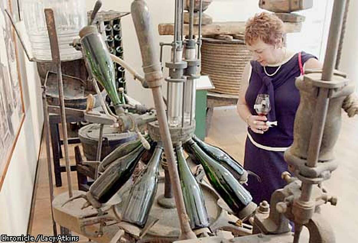 Sandi Borreson looks over the antiques in the Artesa Winery, June 6,02, in Napa. PHOTO BY LACY ATKINS/CHRONICLE