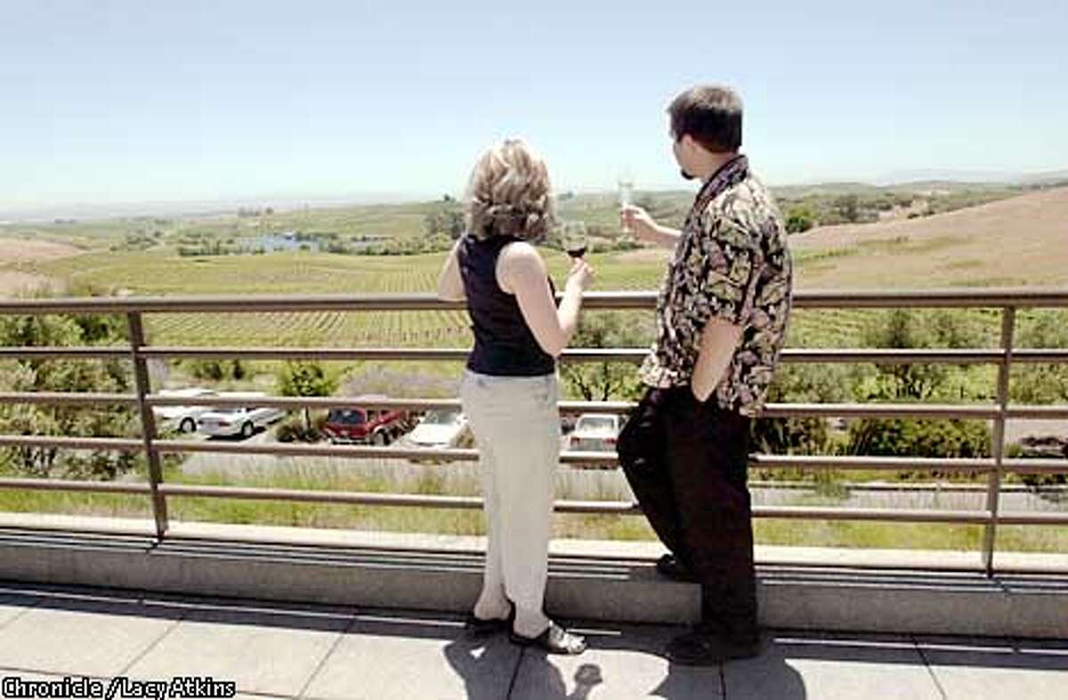 Jenny Grundstrom and Jonathan Wright enjoy the view of vineyards from the Artesa Winery as they sip the wines from the winery, June 6,02, in Napa. PHOTO BY LACY ATKINS/CHRONICLE